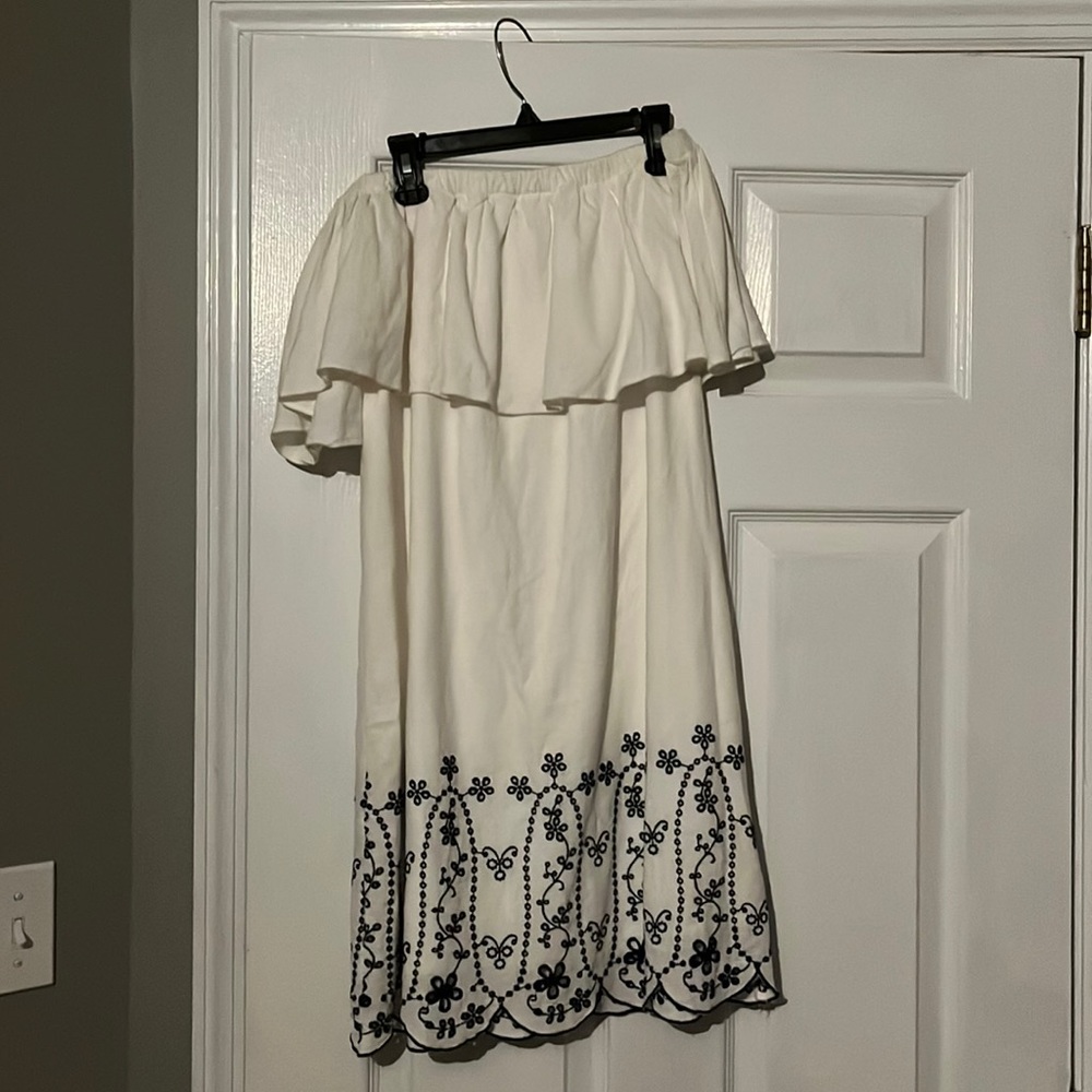 Strapless white dress with flower patterns at bottom. Worn twice.